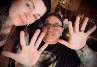two people with tattoos posing for a picture